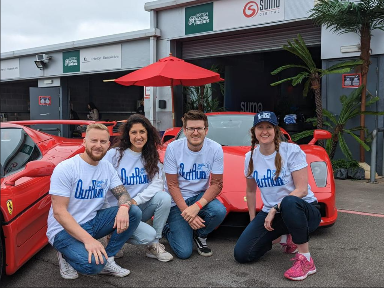 The Sumo Group team at British Racing Greats 2023 - the team pose in front of supercars